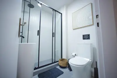 a bathroom with a toilet and a glass shower at ARIS Central Kallithea in Athens