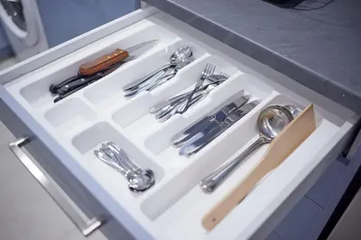 a white drawer with silver utensils in it at ARIS Central Kallithea in Athens