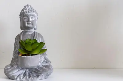 a statue of a buddha with a green plant at Stylish Modern Athens apt in Athens