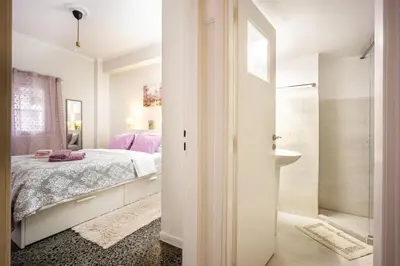 a bedroom with a bed and a walk in shower at Stylish Modern Athens apt in Athens