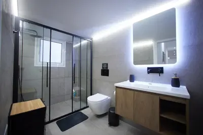a bathroom with a toilet and a sink and a shower at ARIS Kallithea- Big & Bright 3 Bedroom Apartment in Athens