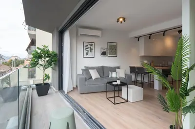 a living room with a couch and a table at Silk Athens Urban Collection in Athens