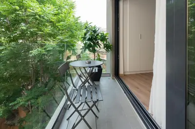a balcony with a table and a plant at Silk Athens Urban Collection in Athens