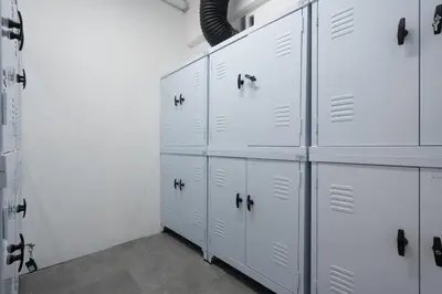 a row of white lockers in a room at Silk Athens Urban Collection in Athens