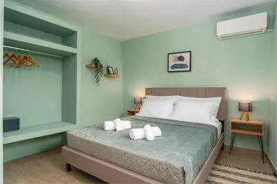 a bedroom with a bed with two towels on it at Palm & Spa in Barbaliáki