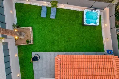 an overhead view of a backyard with a green lawn at Palm & Spa in Barbaliáki
