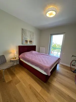 a bedroom with a large bed and a window at Glyfada Gorgeous Penthouse in Athens