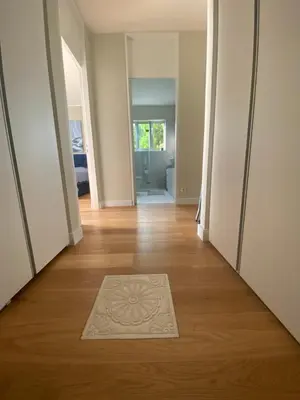 a hallway with a rug on a hard wood floor at Glyfada Gorgeous Penthouse in Athens