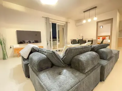 a living room with a couch and a television at Bluebay Acropolis view comfort apartment 8 in Athens