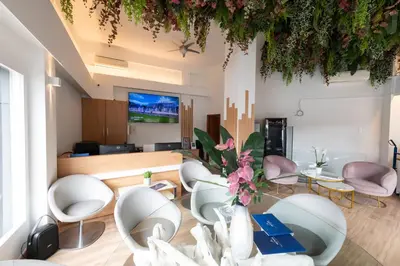 a living room with white chairs and a table at Medluxe family apartment! in Athens
