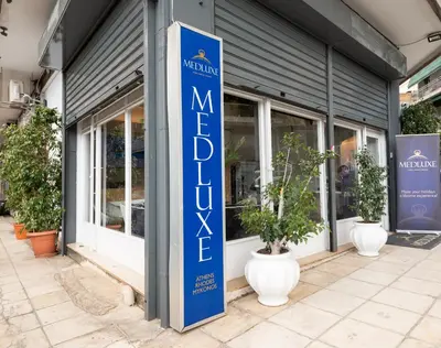 a blue sign on the side of a store at Medluxe family apartment! in Athens