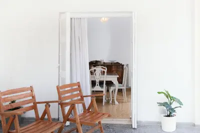 a living room with two chairs and a table at Sunrise Apartment By Athens Airport in Spáta