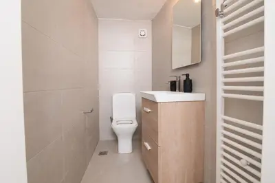 a small bathroom with a toilet and a sink at Sunrise Apartment By Athens Airport in Spáta