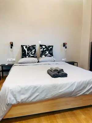 a bed with two pairs of towels on it at Bluebay Cozy apartment 18 in Athens