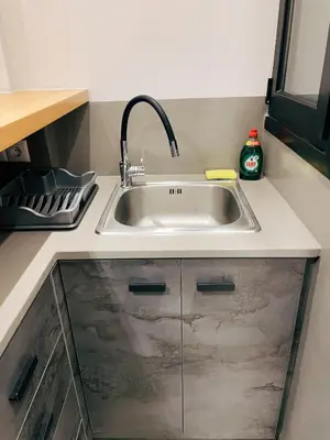 a kitchen sink with a faucet on a counter at Bluebay Cozy apartment 18 in Athens