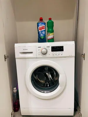 a washing machine with two bottles on top of it at Bluebay Cozy apartment 18 in Athens
