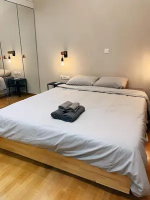 a large white bed with two towels on it at Bluebay Cozy apartment 18 in Athens