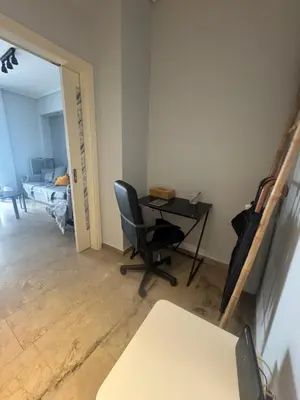 a room with a desk and a chair and a bed at Cozy faliro in Piraeus