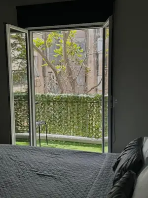 a bedroom with a bed and a sliding glass door at Gkr Luxury Apartments Metro Petralona in Athens