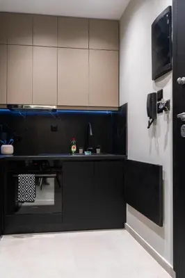a kitchen with black and white cabinets and a sink at Gkr Luxury Apartments Metro Petralona in Athens