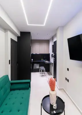 a living room with a green couch and a table at Gkr Luxury Apartments Metro Petralona in Athens