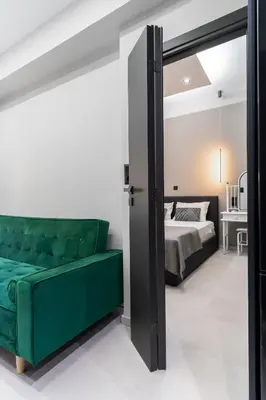 a bedroom with a green couch and a bed at Gkr Luxury Apartments Metro Petralona in Athens