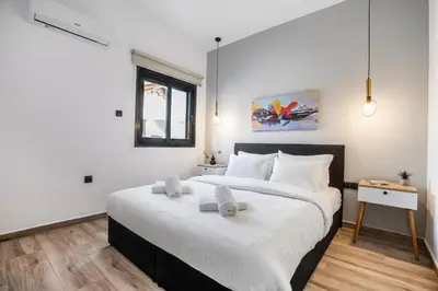 a bedroom with a large bed and a window at Sway - Chic 1-Bedroom Apartment & Balcony in Athens in Athens