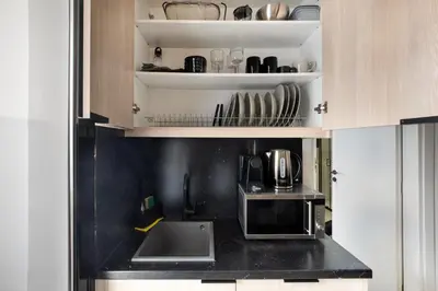 a kitchen with a sink and a microwave at Sway - Chic 1-Bedroom Apartment & Balcony in Athens in Athens