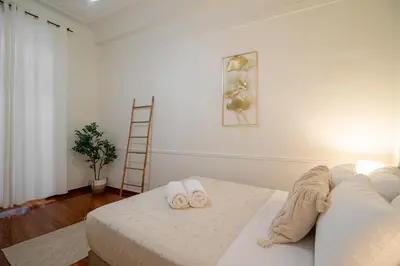 a bedroom with a bed with two slippers on it at Acropolis Rooftop Ermou in Athens