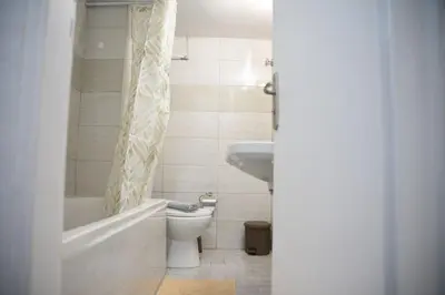 a bathroom with a tub and a toilet and a sink at Constantine cozy apartment in Piraeus