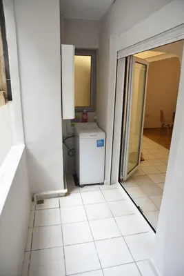 a kitchen with a washer and dryer in a room at Constantine cozy apartment in Piraeus