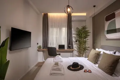 a bedroom with a bed with a hat on it at Asty60 - Cozy Athen's Apartment in Athens