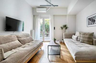 a living room with a couch and a tv at Belmont - 2 BR Apartment & Balcony in Athens in Athens