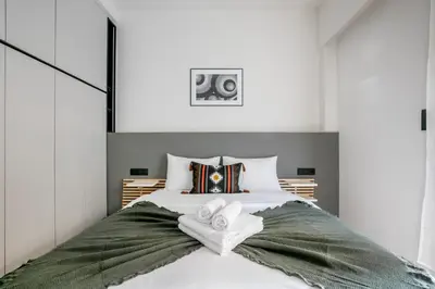 a bedroom with a large bed with towels on it at Belmont - 2 BR Apartment & Balcony in Athens in Athens