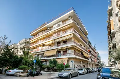 a tall building with cars parked in front of it at Belmont - 2 BR Apartment & Balcony in Athens in Athens