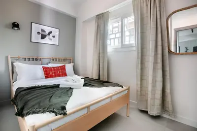 a bedroom with a bed and a window at Belmont - 2 BR Apartment & Balcony in Athens in Athens