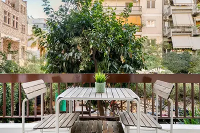 a table and chairs on a balcony with a tree at Belmont - 2 BR Apartment & Balcony in Athens in Athens