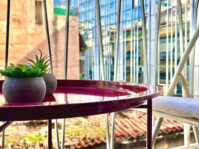 a purple table with a potted plant on a balcony at Bright Athens Apt Near Metro, Balcony & Workspace in Athens