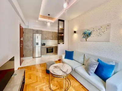 a living room with a couch and a table at Bright Athens Apt Near Metro, Balcony & Workspace in Athens
