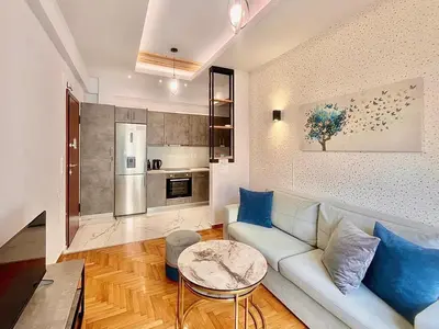 a living room with a couch and a table at Bright Athens Apt Near Metro, Balcony & Workspace in Athens