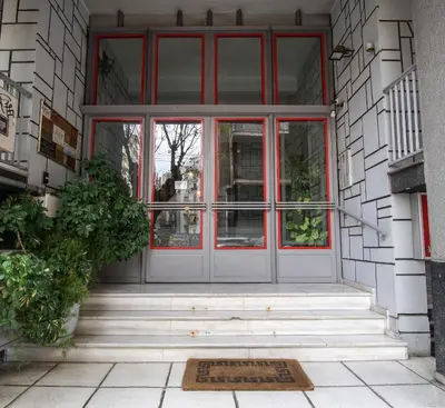 a front door of a building with a mat in front at Cozy Nest, One-Bedroom Flat in Athens