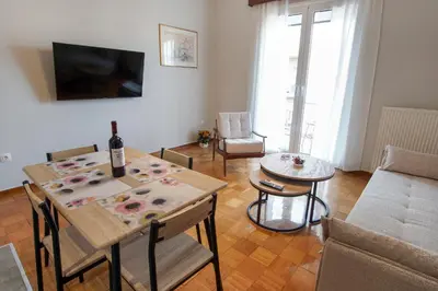 a living room with a table with a bottle of wine on it at Cozy Nest, One-Bedroom Flat in Athens