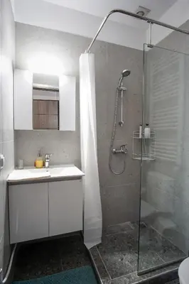 a bathroom with a shower with a sink and a shower at Cozy Nest, One-Bedroom Flat in Athens