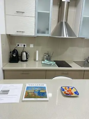 a book sitting on a counter in a kitchen at Bluebay Cozy Aparment in Athens