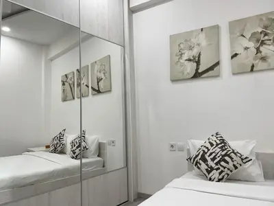 a white room with two beds and a mirror at Bluebay Cozy Aparment in Athens