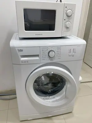 a microwave sitting on top of a washing machine at Bluebay Cozy Aparment in Athens