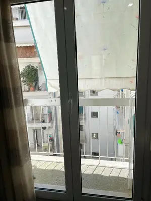 an open window with a view of a building at Bluebay Cozy Aparment in Athens