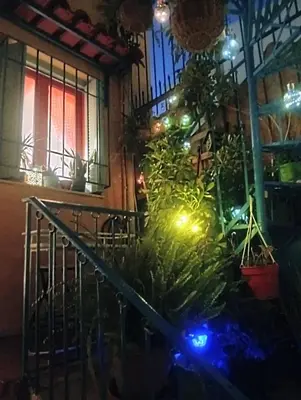 a stairway with christmas lights in a building at The Happy Town House , 300m from the metro station in Athens