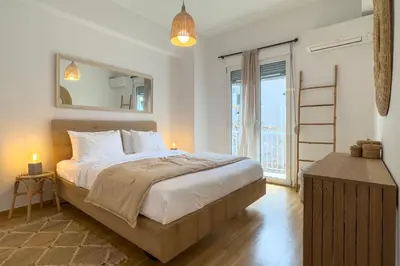a bedroom with a large bed and a large window at Phaedrus Living Kallithea Heights Residence in Athens