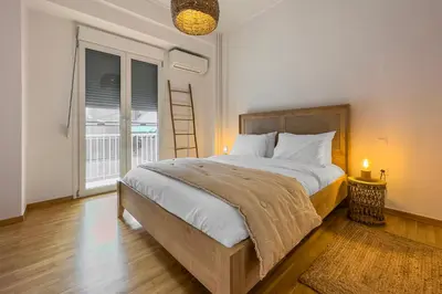 a bedroom with a large bed and a large window at Phaedrus Living Kallithea Heights Residence in Athens